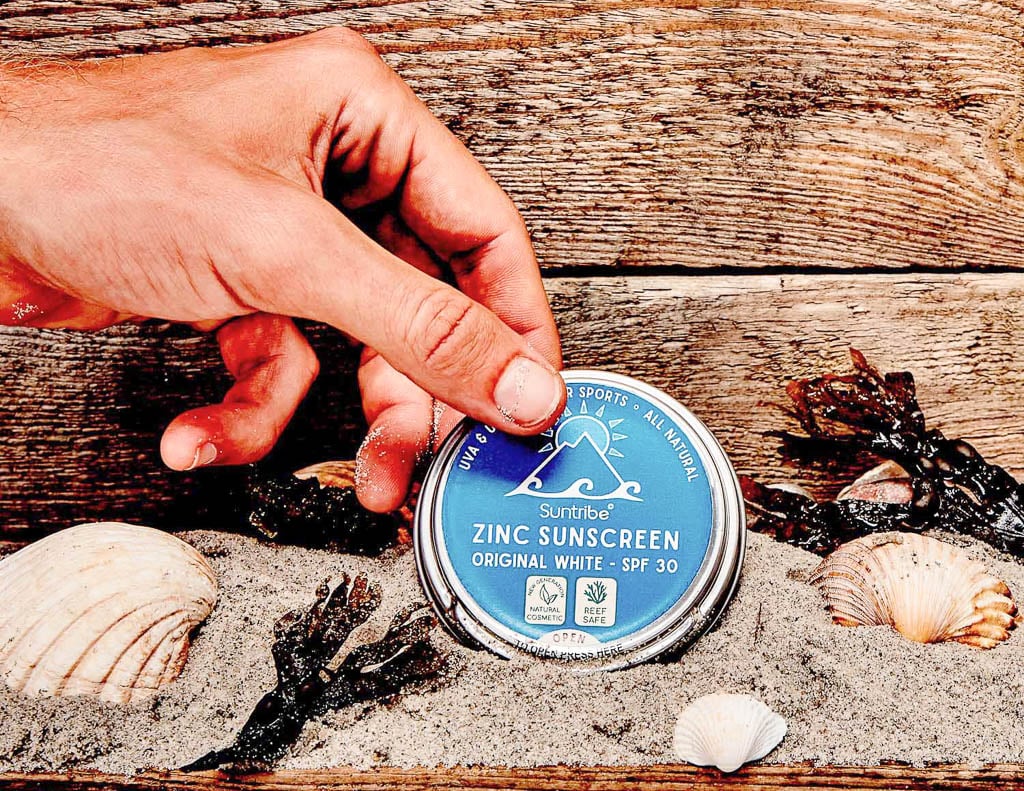 Hand holding zinc sunscreen